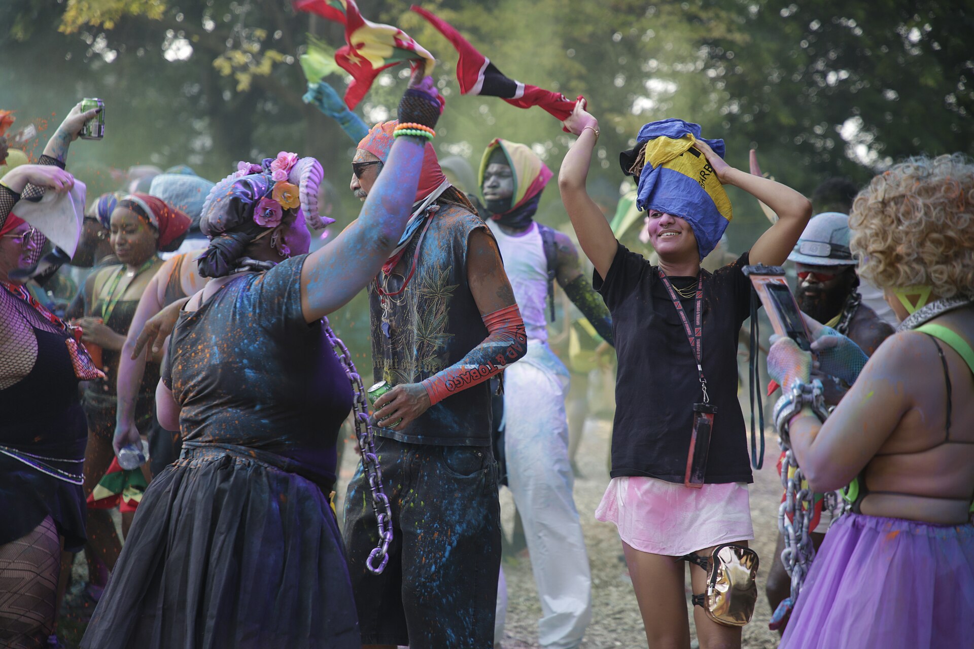 J'ouvert revellers in paint and powder waving flags