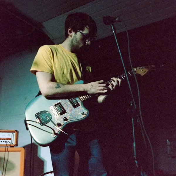 Me holding my guitar on stage