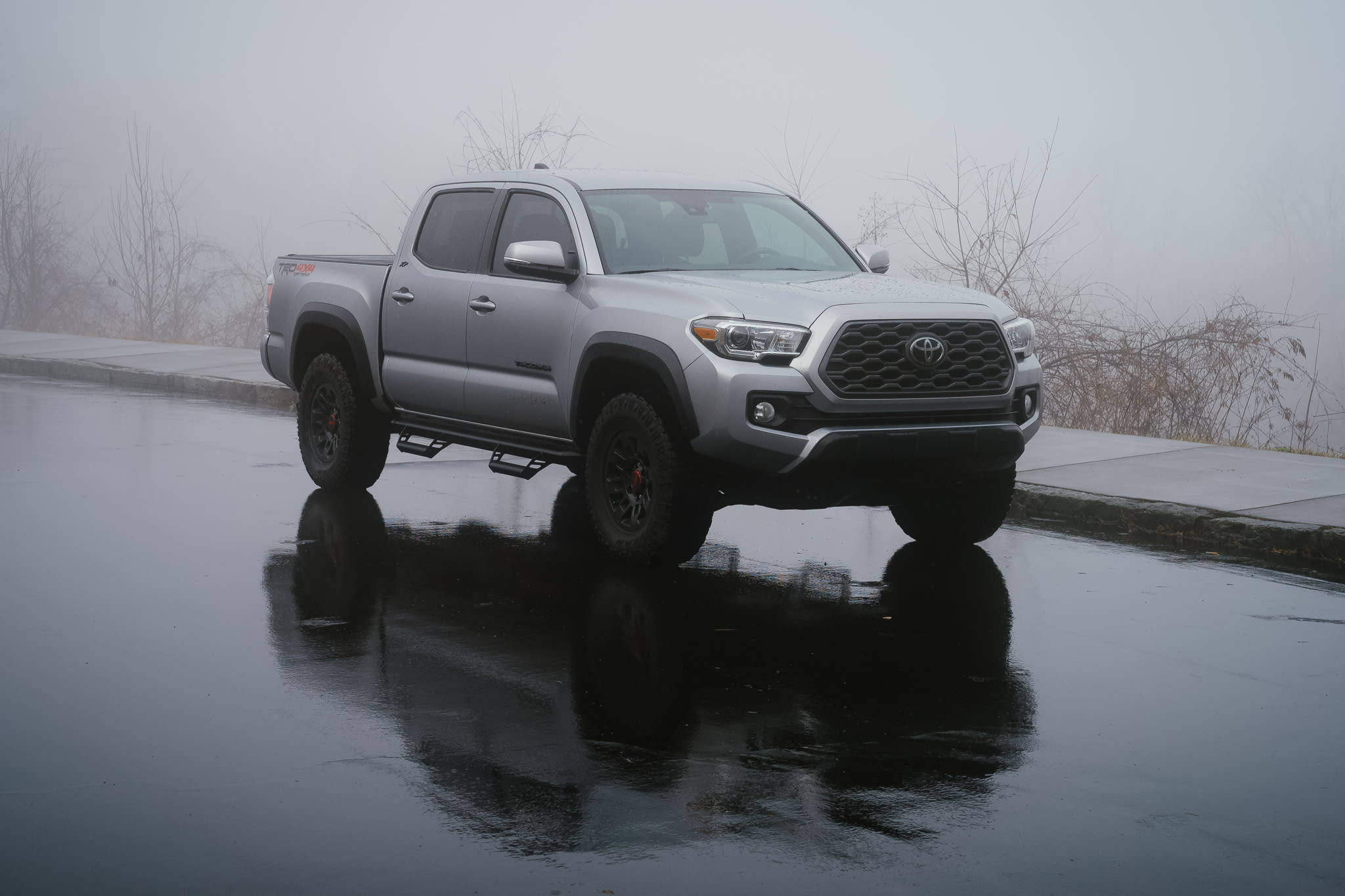 a truck is parked on a foggy overlook