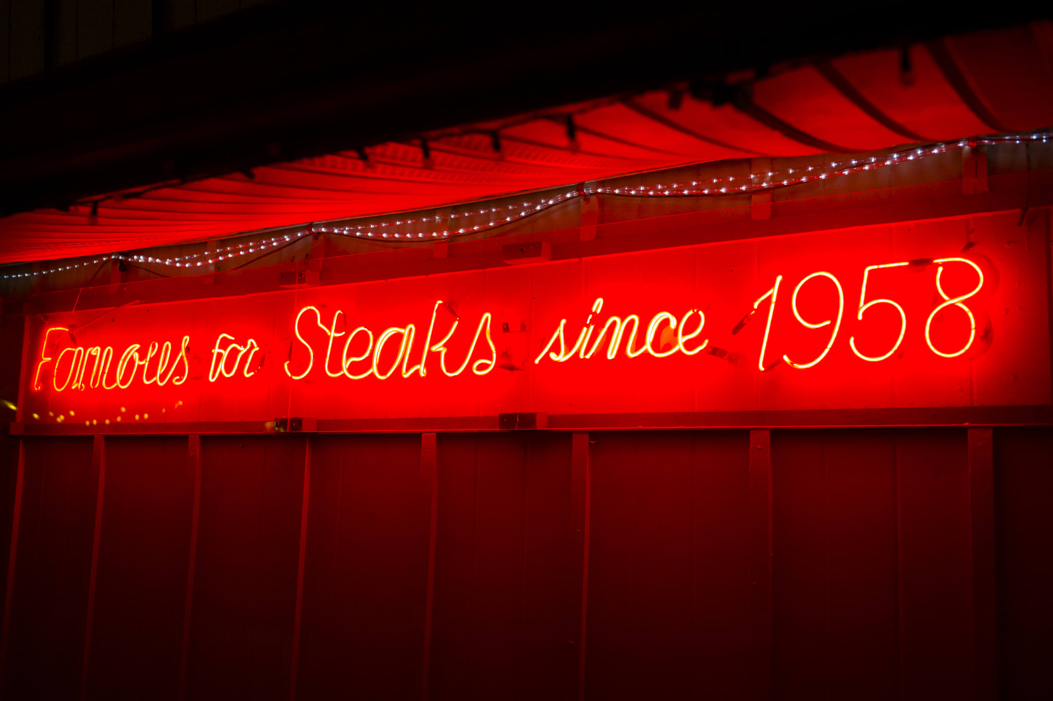 neon sign reads famous for steaks since 1958