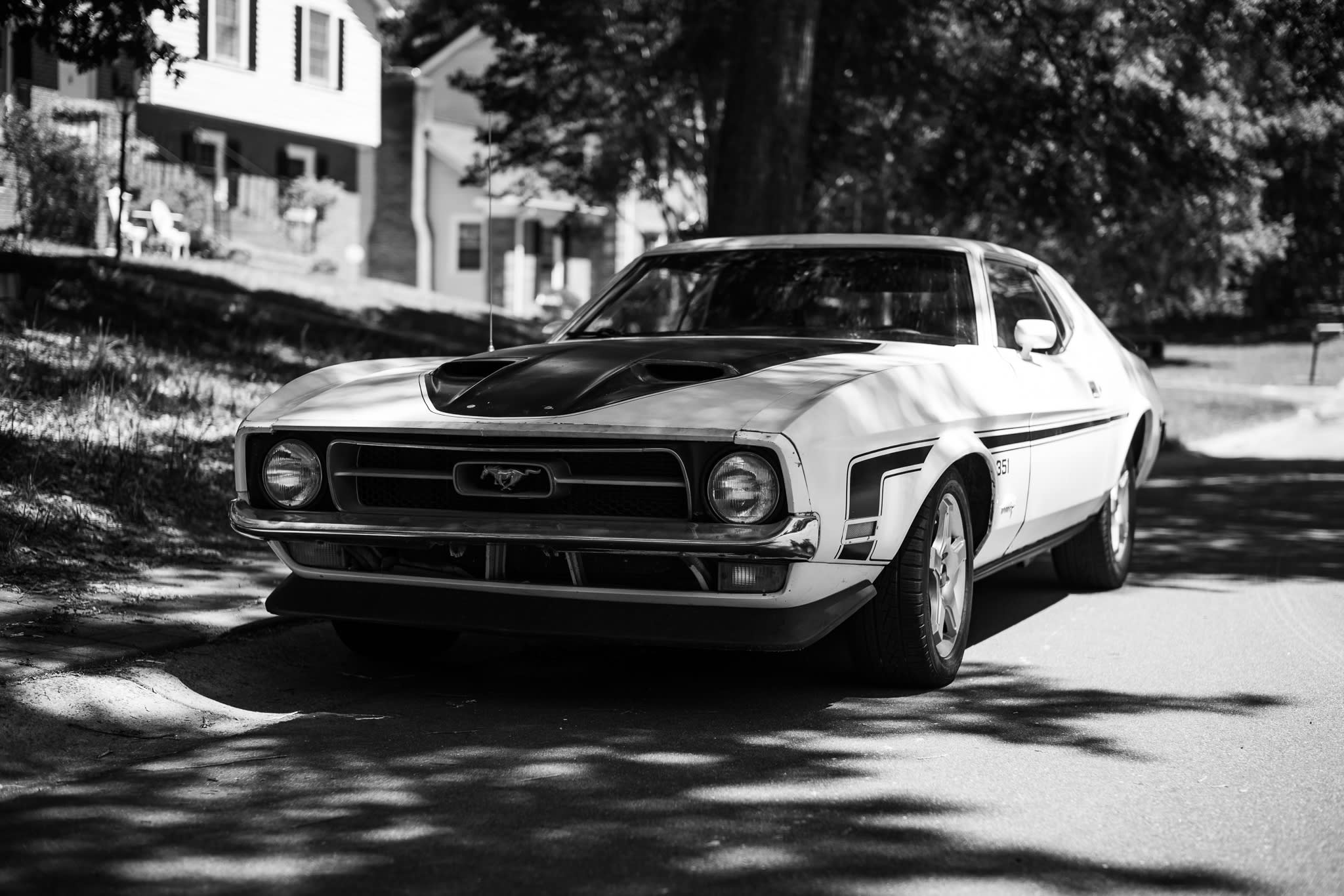 photograph of a 1971 351 Boss Mustang parked on a neighborhood street