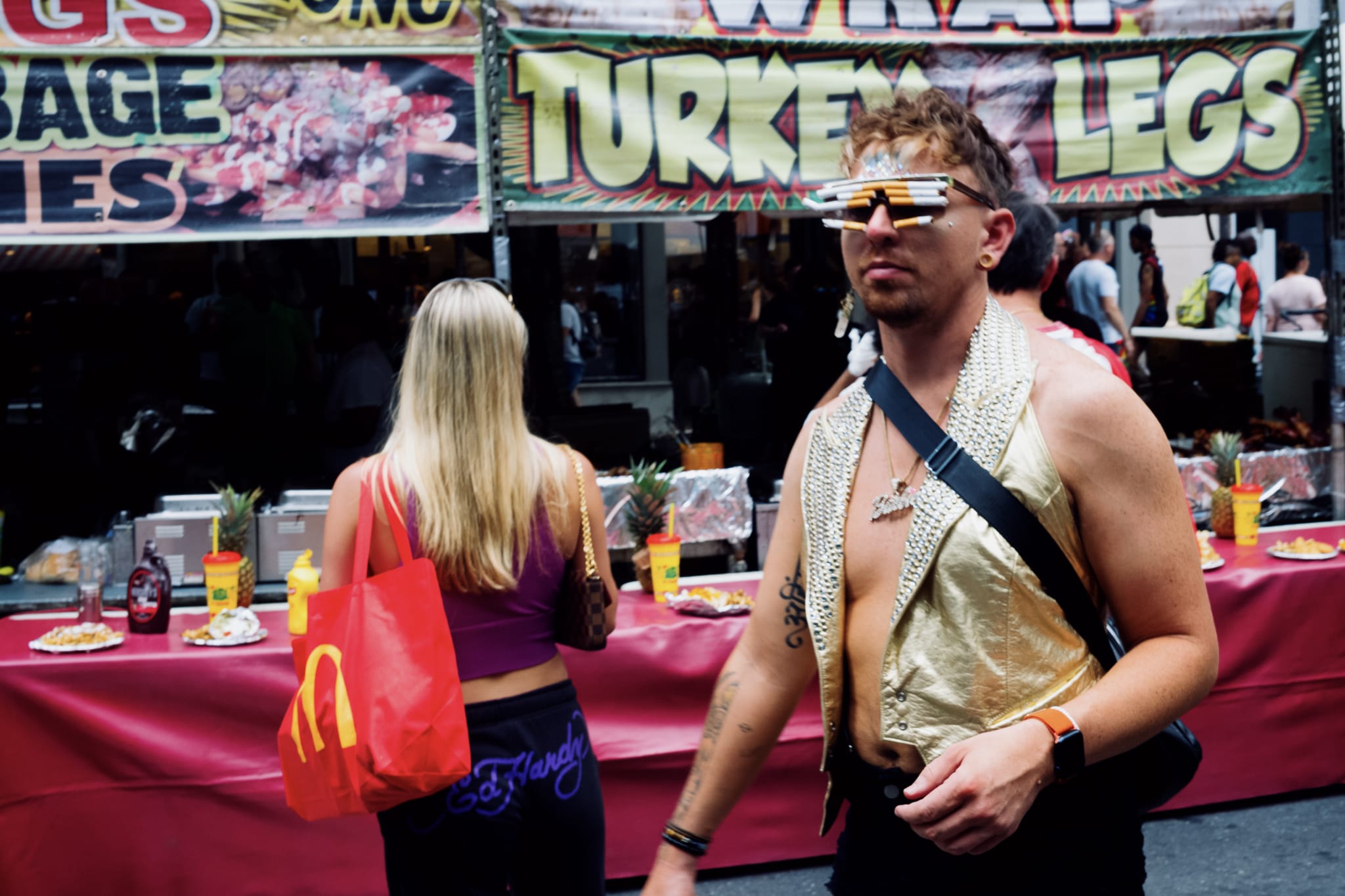 person standing in front of turkey leg vendor with sun shades made of cigarettes