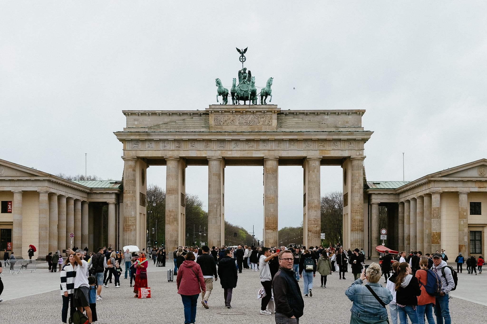 Brandenburg Gate, an 18th century monument, during the day surrounded by a large crowd of tourists