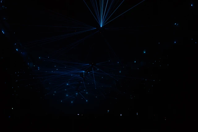 splotches and narrow beams of light scattered in a darkroom