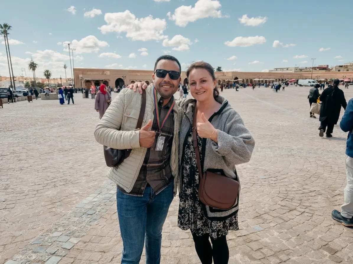 Tourist with Moroccan guide at Jemaa El-Fnaa Square Marrakech