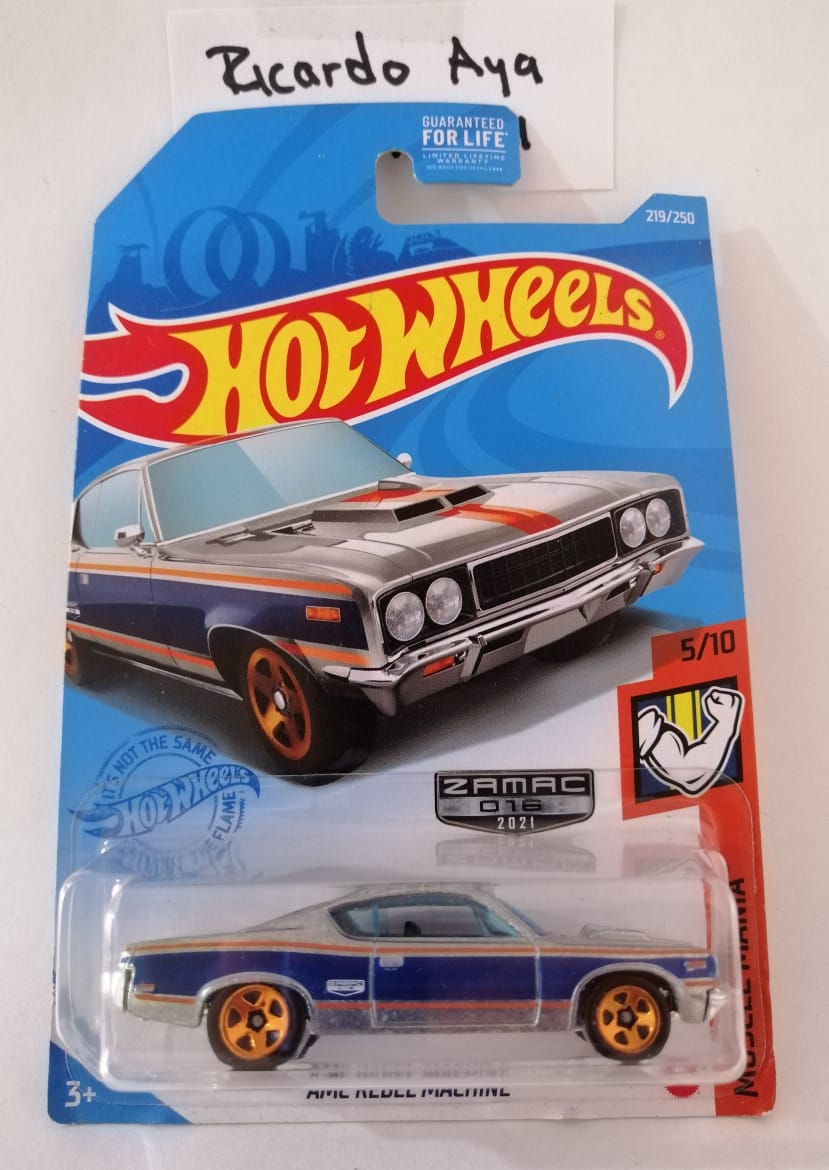 Front of satchel with blue canvas body, black straps and handle, drawstring top, and front zipper pouch.