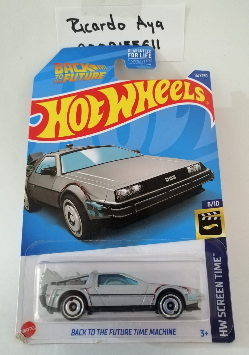 Front of satchel with blue canvas body, black straps and handle, drawstring top, and front zipper pouch.