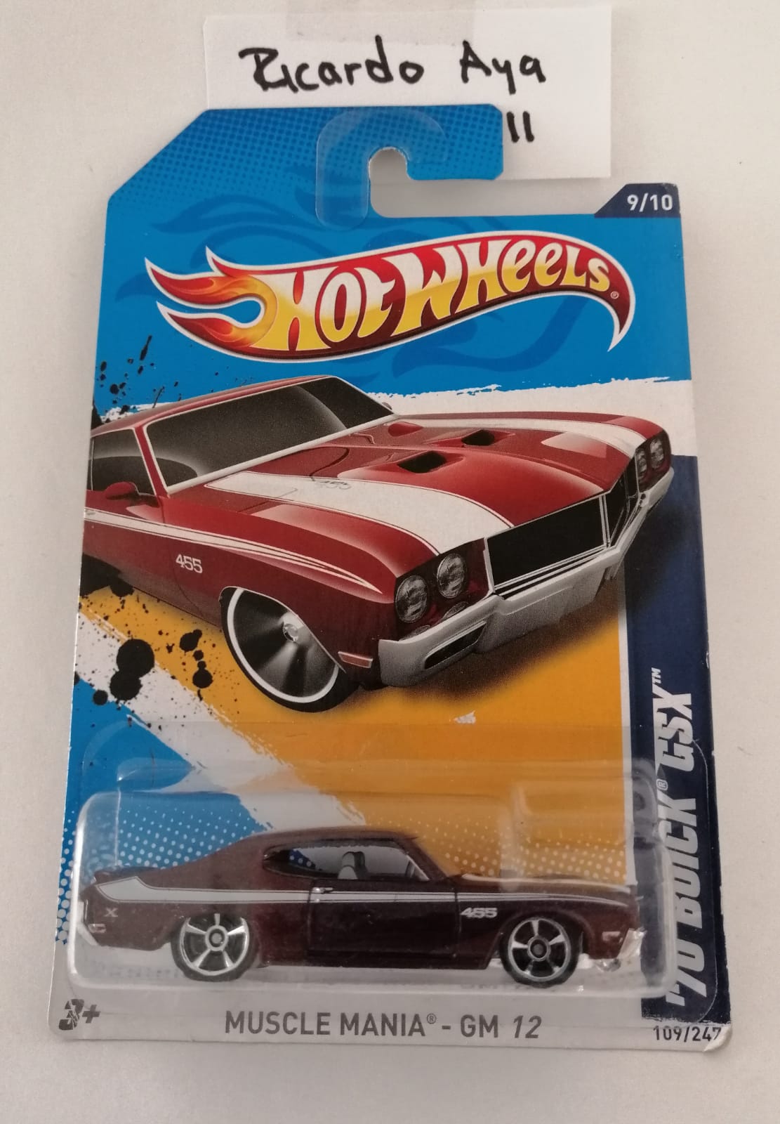 Front of satchel with blue canvas body, black straps and handle, drawstring top, and front zipper pouch.