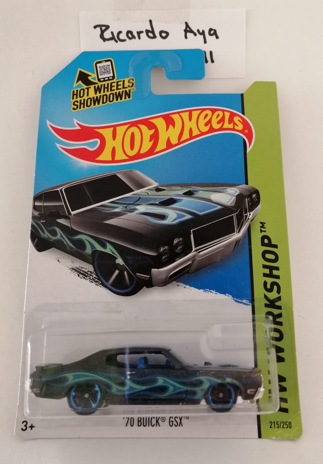 Front of satchel with blue canvas body, black straps and handle, drawstring top, and front zipper pouch.