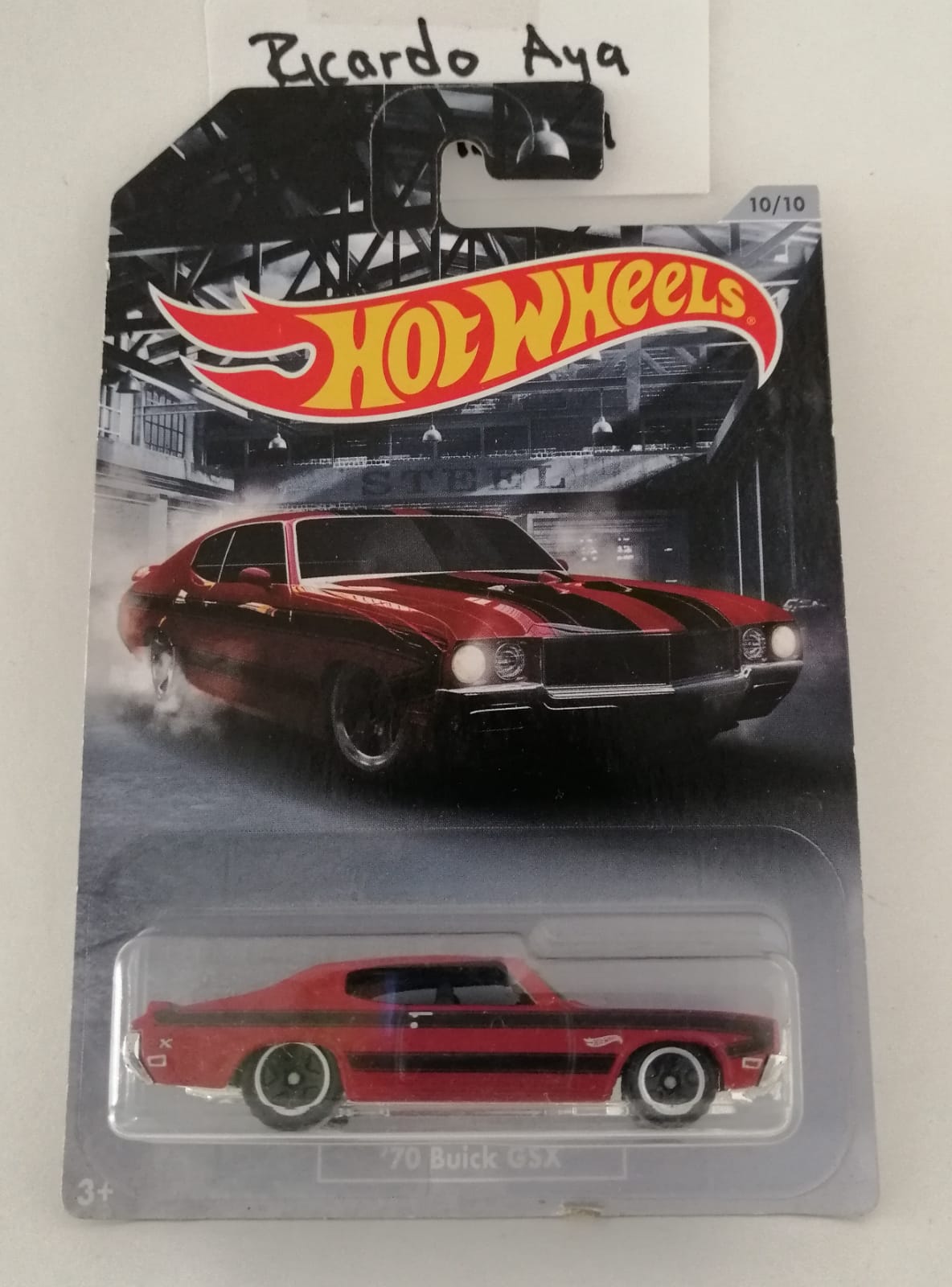 Front of satchel with blue canvas body, black straps and handle, drawstring top, and front zipper pouch.