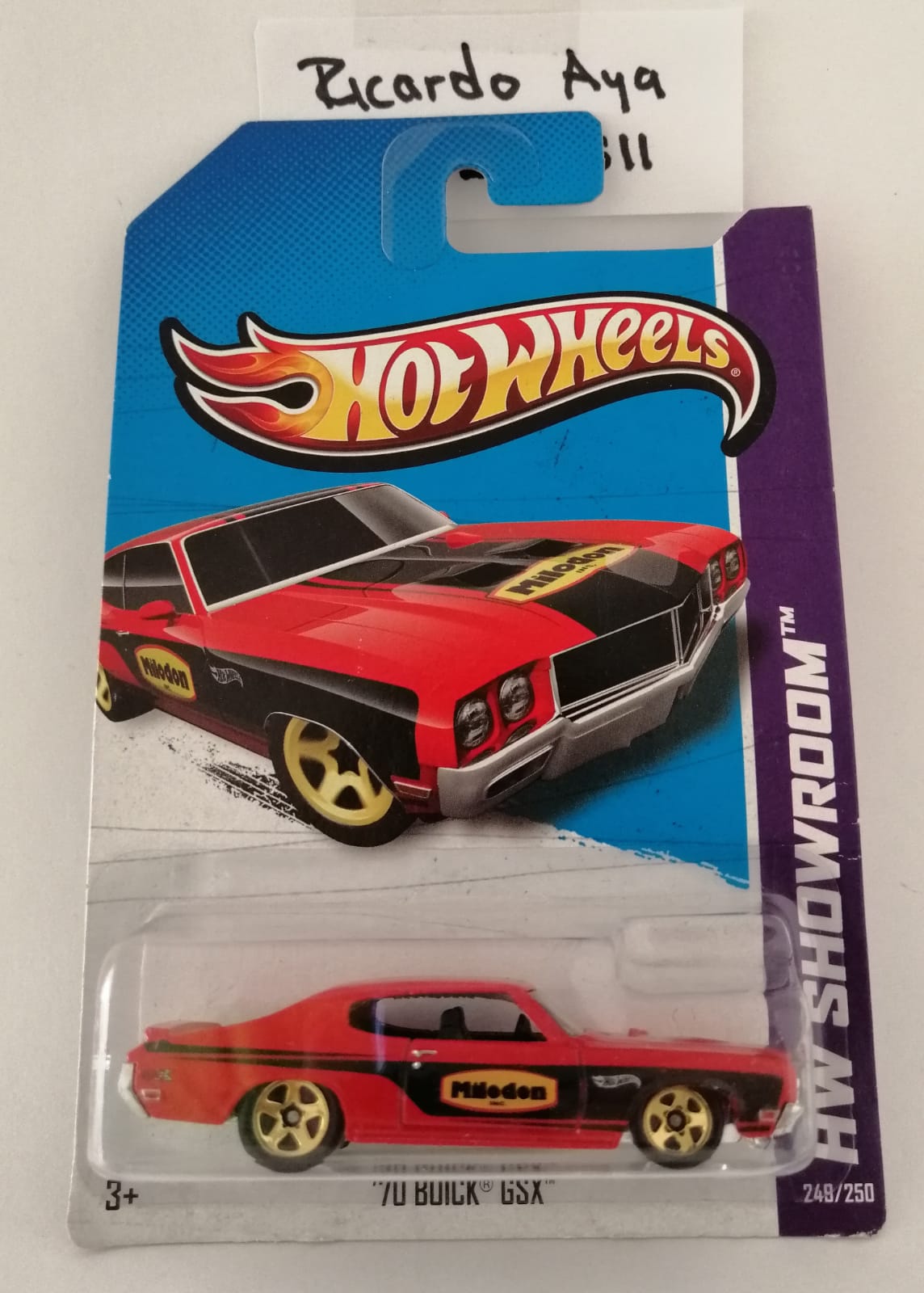 Front of satchel with blue canvas body, black straps and handle, drawstring top, and front zipper pouch.