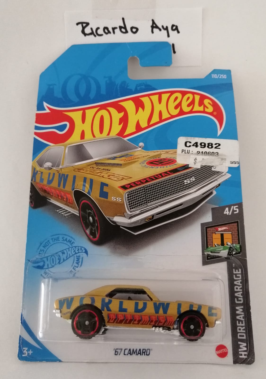 Front of satchel with blue canvas body, black straps and handle, drawstring top, and front zipper pouch.