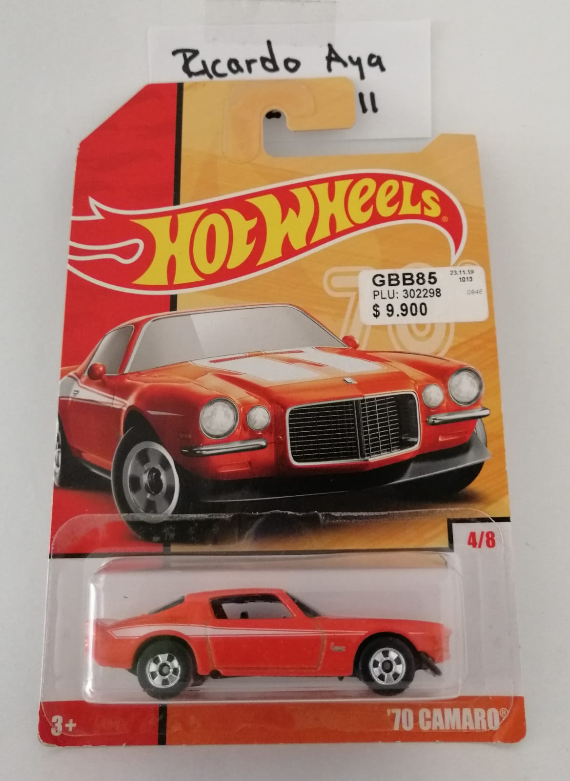 Front of satchel with blue canvas body, black straps and handle, drawstring top, and front zipper pouch.