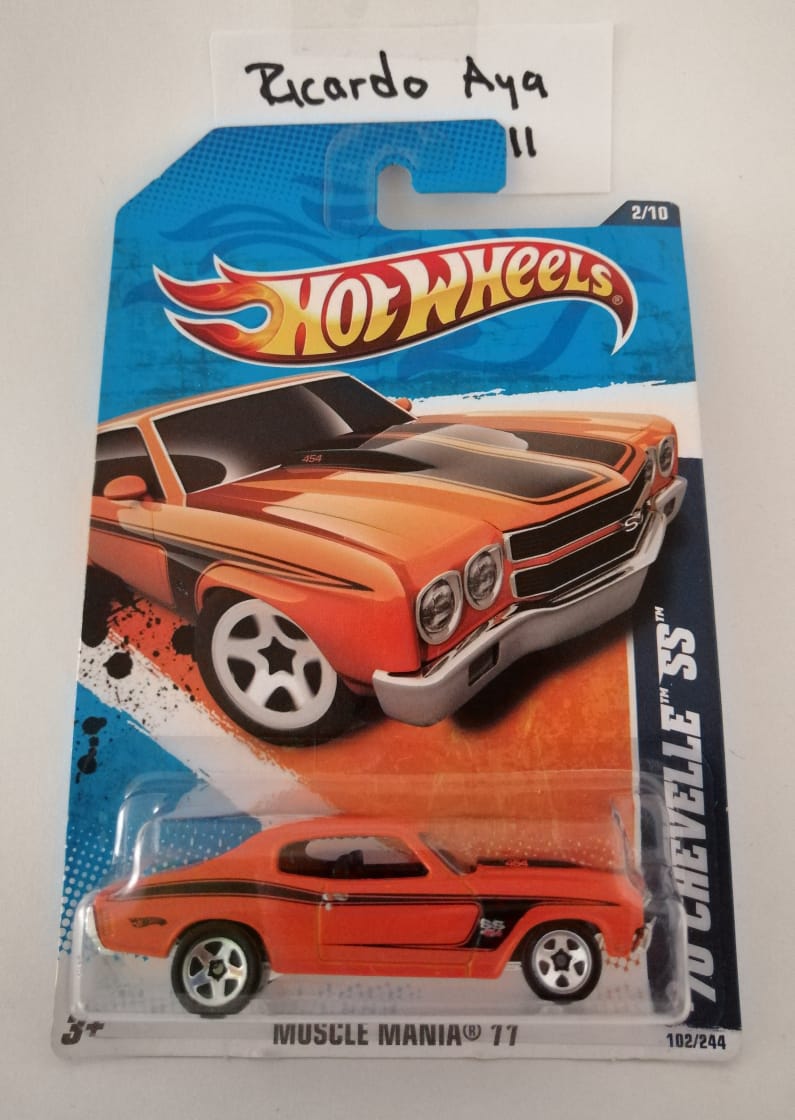 Front of satchel with blue canvas body, black straps and handle, drawstring top, and front zipper pouch.