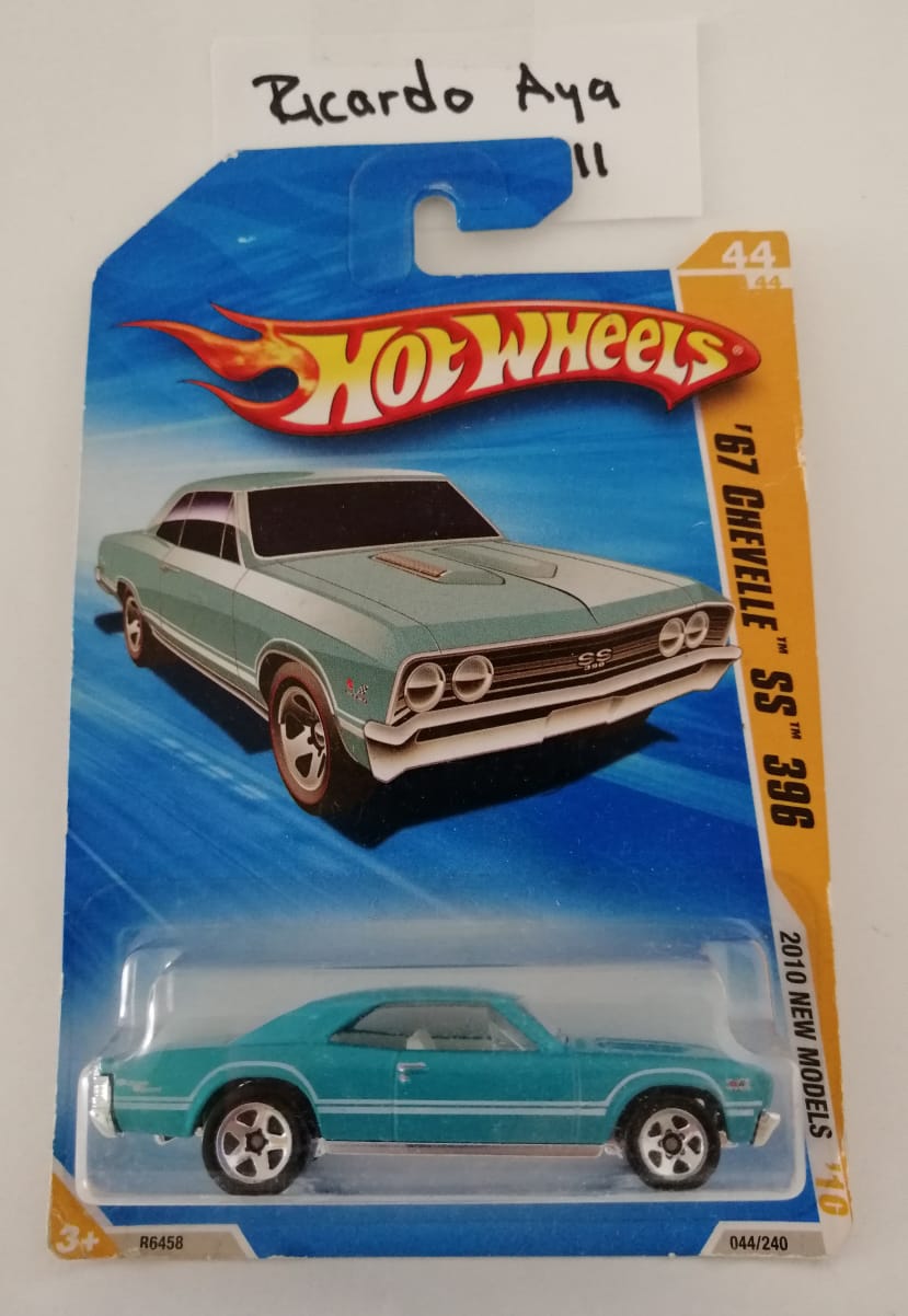 Front of satchel with blue canvas body, black straps and handle, drawstring top, and front zipper pouch.