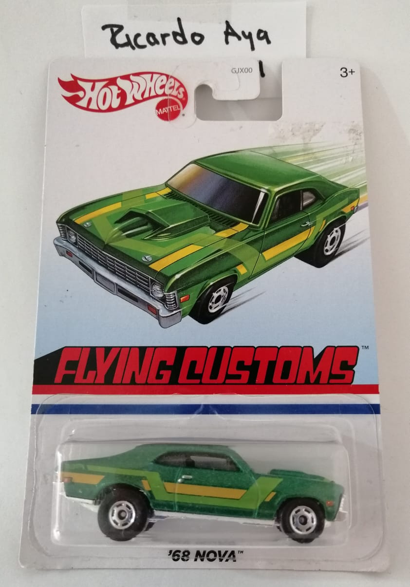 Front of satchel with blue canvas body, black straps and handle, drawstring top, and front zipper pouch.