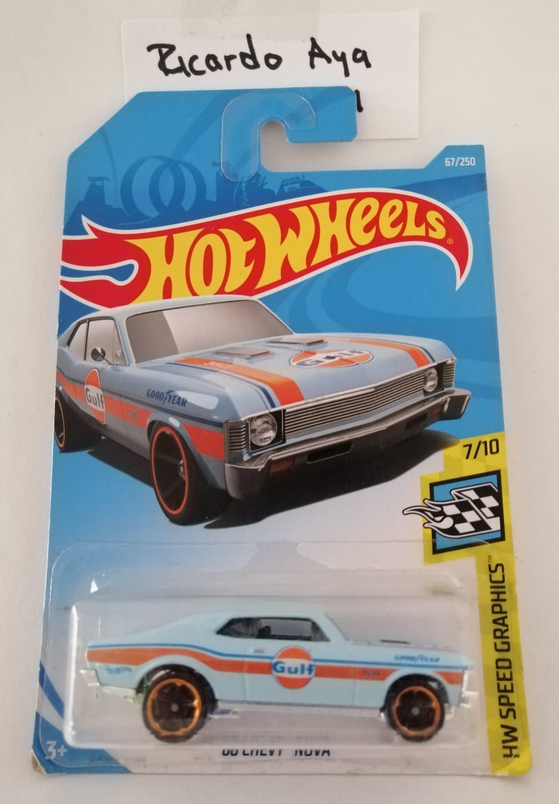 Front of satchel with blue canvas body, black straps and handle, drawstring top, and front zipper pouch.