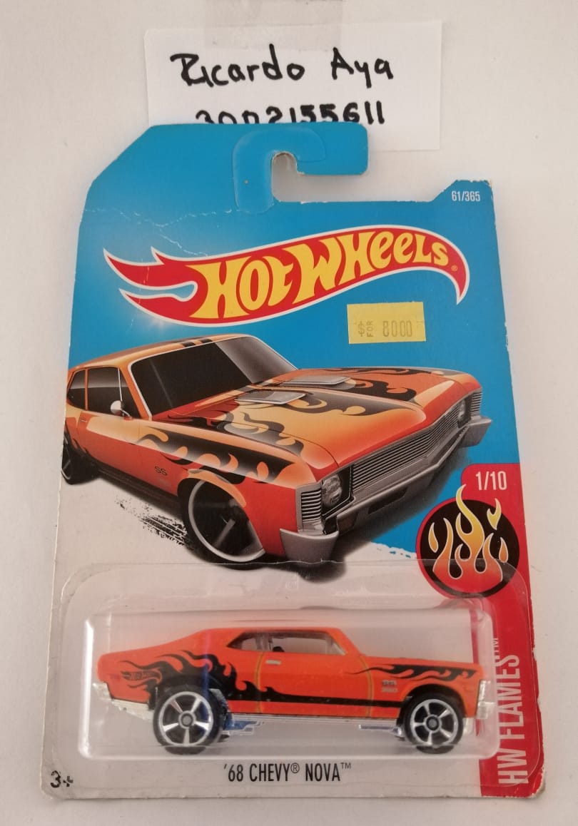 Front of satchel with blue canvas body, black straps and handle, drawstring top, and front zipper pouch.