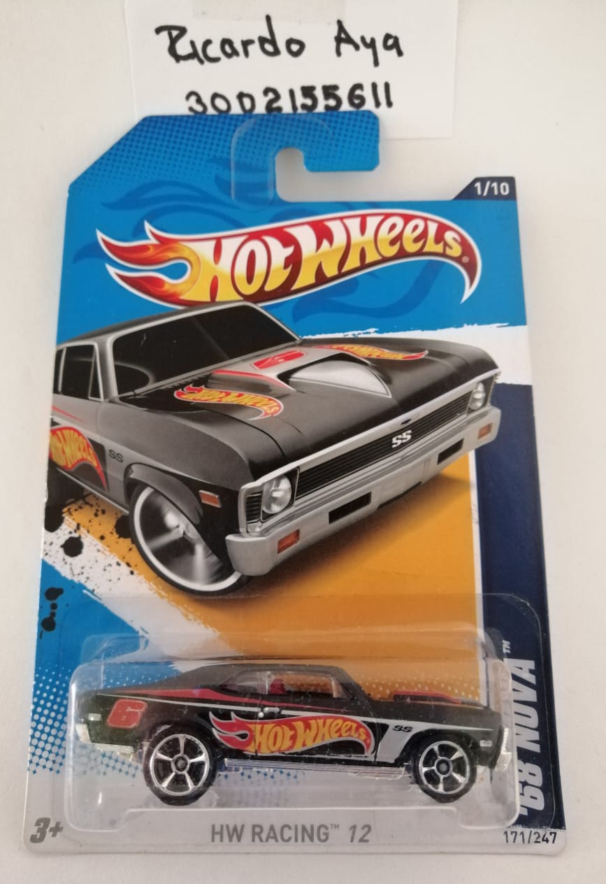 Front of satchel with blue canvas body, black straps and handle, drawstring top, and front zipper pouch.