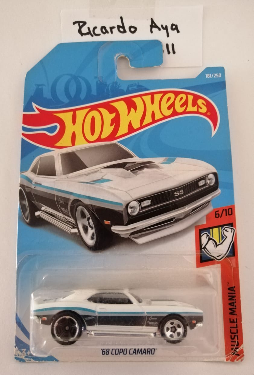 Front of satchel with blue canvas body, black straps and handle, drawstring top, and front zipper pouch.