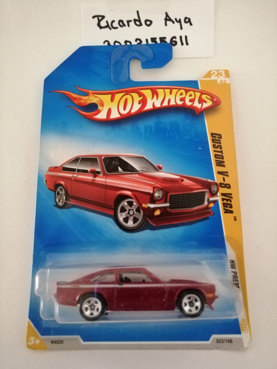 Front of satchel with blue canvas body, black straps and handle, drawstring top, and front zipper pouch.