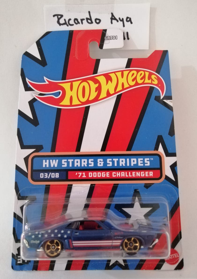 Front of satchel with blue canvas body, black straps and handle, drawstring top, and front zipper pouch.