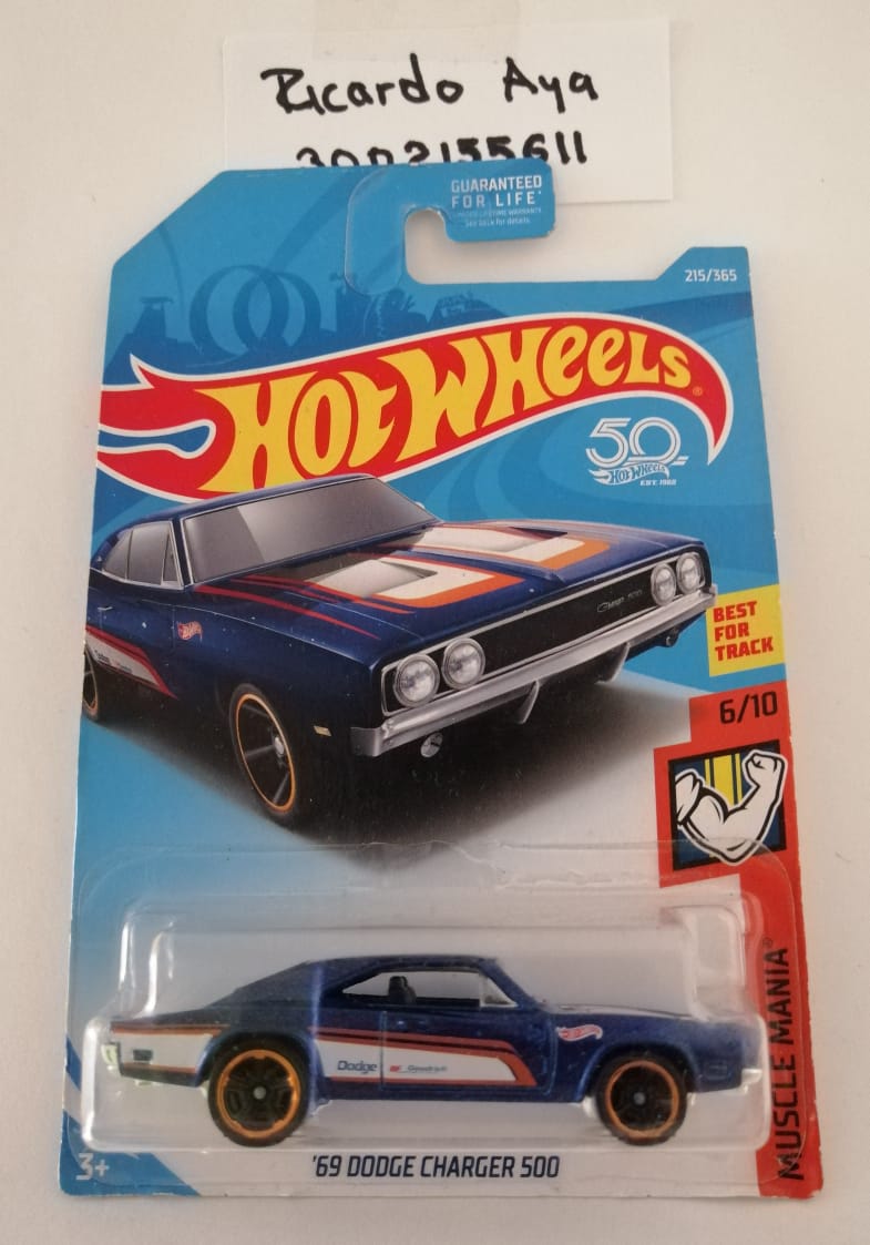 Front of satchel with blue canvas body, black straps and handle, drawstring top, and front zipper pouch.