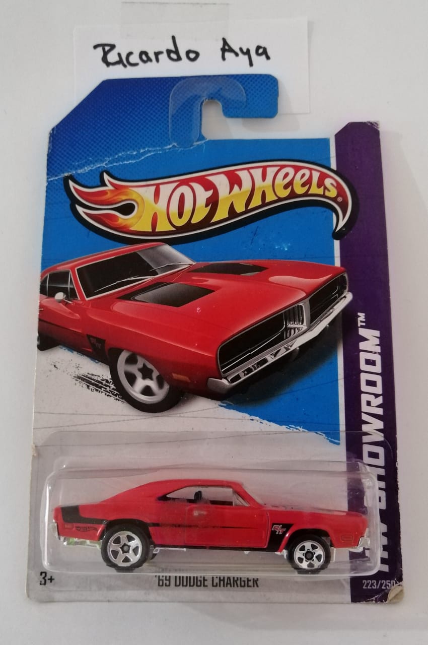 Front of satchel with blue canvas body, black straps and handle, drawstring top, and front zipper pouch.