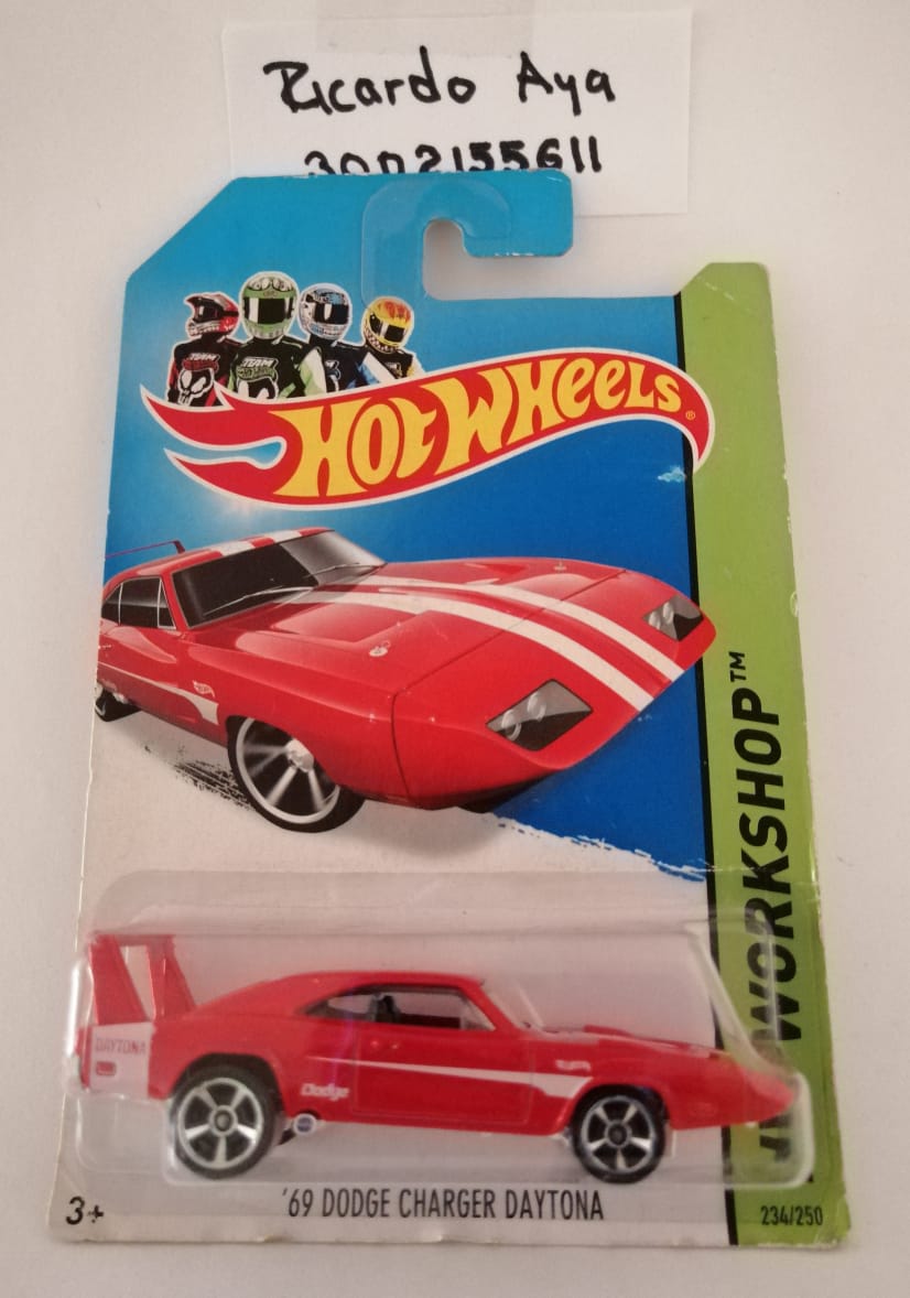 Front of satchel with blue canvas body, black straps and handle, drawstring top, and front zipper pouch.