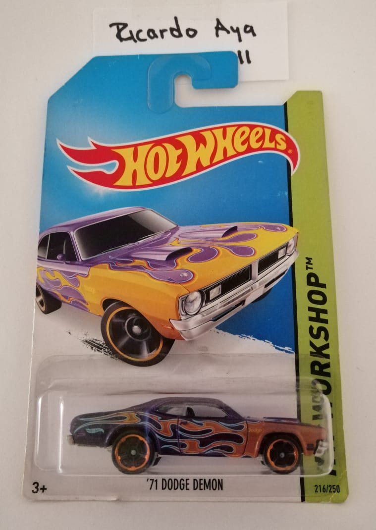 Front of satchel with blue canvas body, black straps and handle, drawstring top, and front zipper pouch.