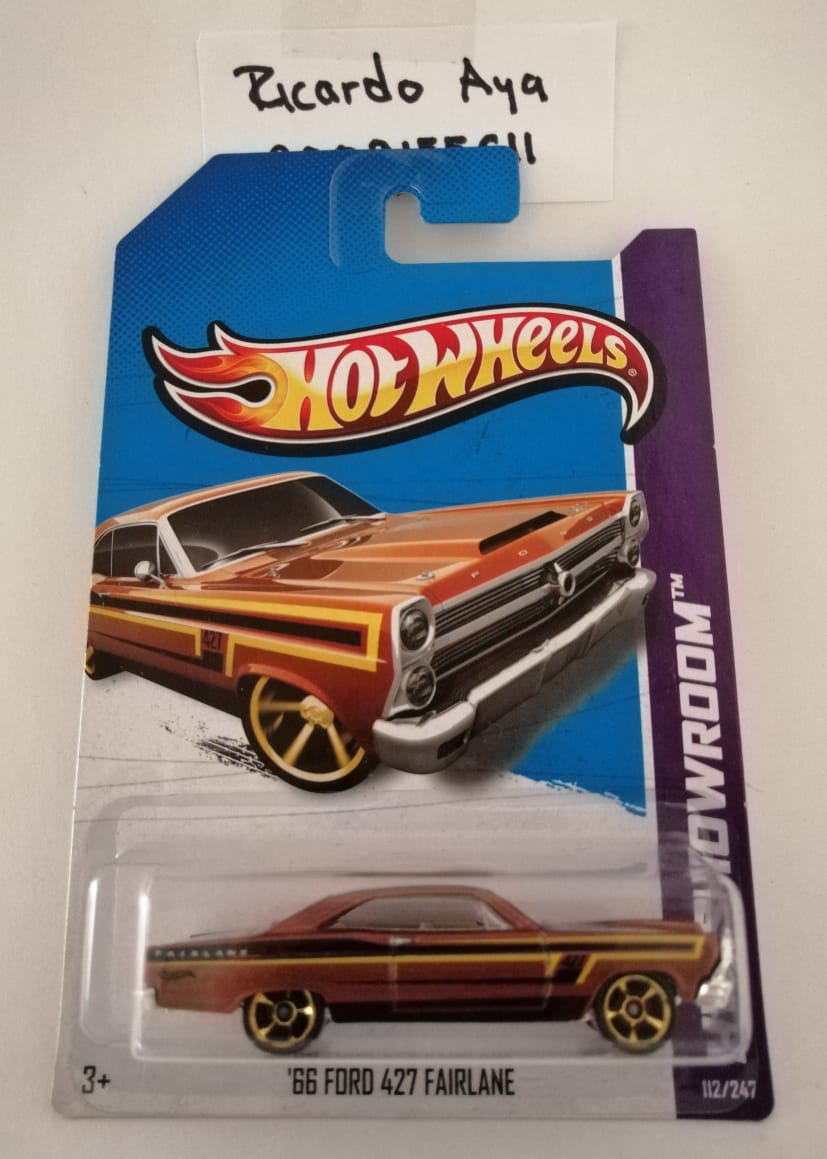 Front of satchel with blue canvas body, black straps and handle, drawstring top, and front zipper pouch.