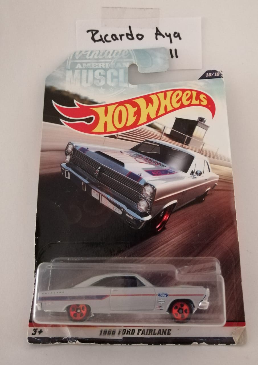 Front of satchel with blue canvas body, black straps and handle, drawstring top, and front zipper pouch.