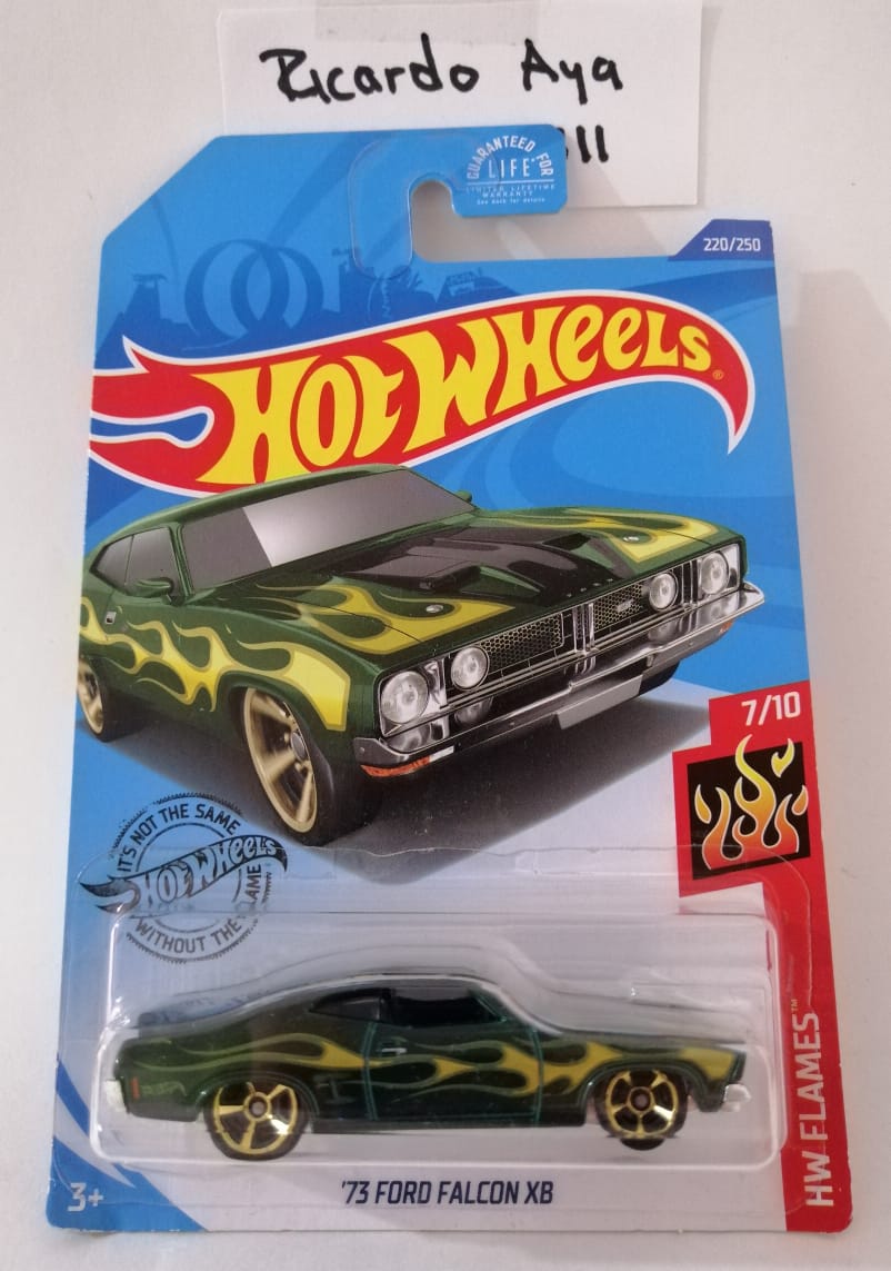 Front of satchel with blue canvas body, black straps and handle, drawstring top, and front zipper pouch.