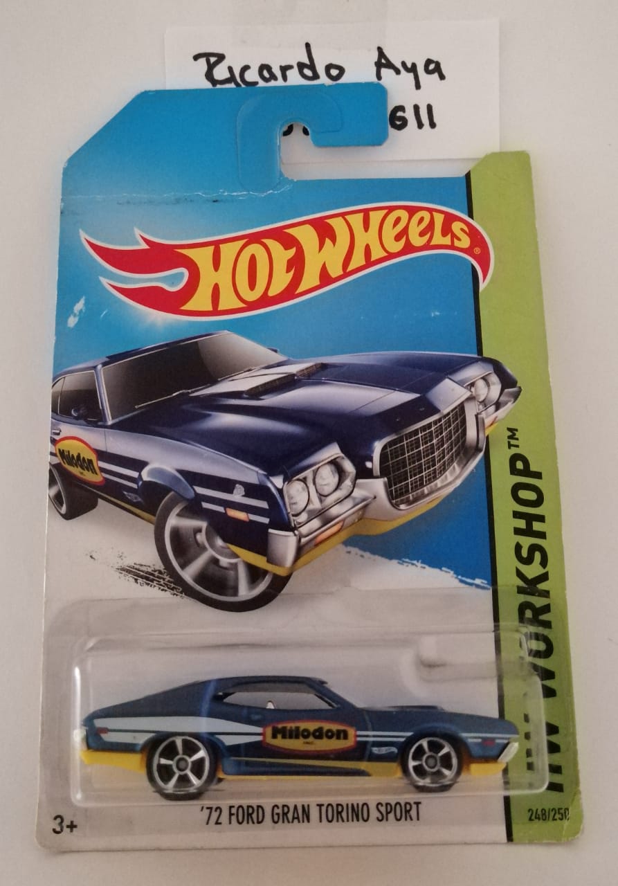 Front of satchel with blue canvas body, black straps and handle, drawstring top, and front zipper pouch.