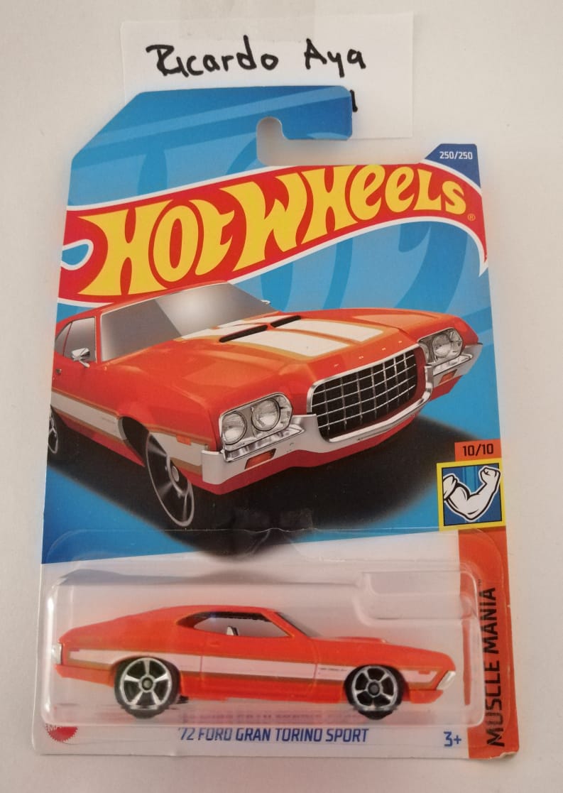 Front of satchel with blue canvas body, black straps and handle, drawstring top, and front zipper pouch.