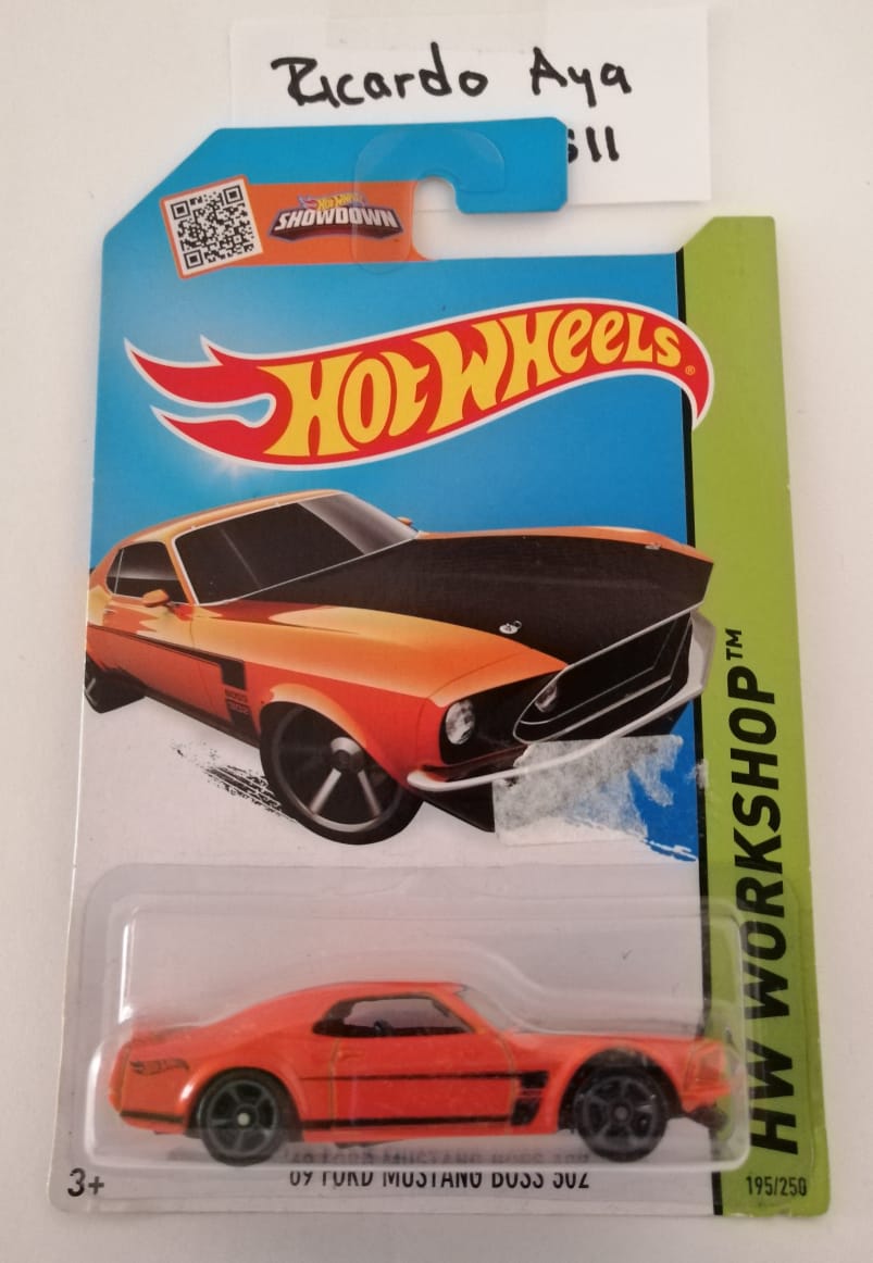 Front of satchel with blue canvas body, black straps and handle, drawstring top, and front zipper pouch.