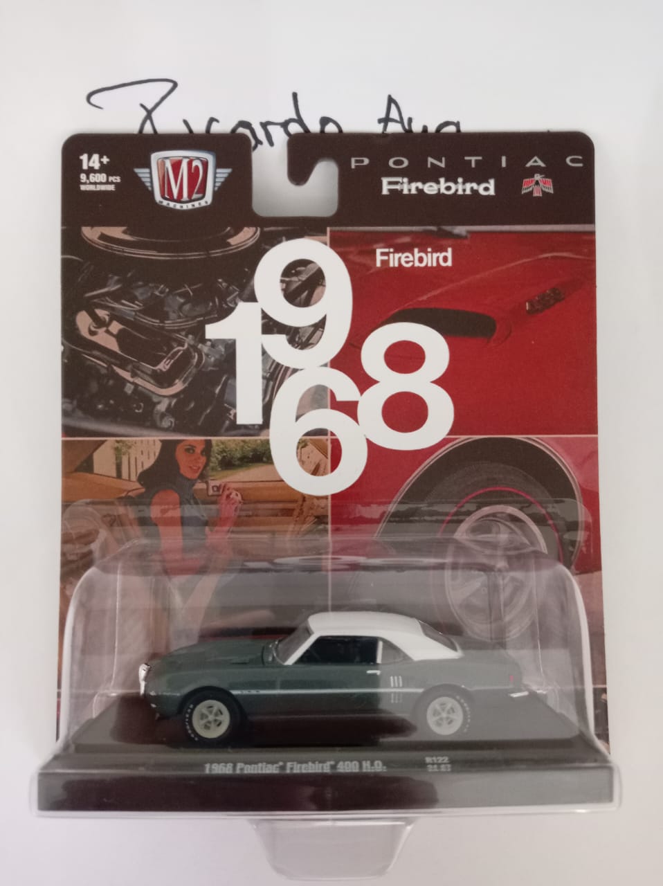 Front of satchel with blue canvas body, black straps and handle, drawstring top, and front zipper pouch.