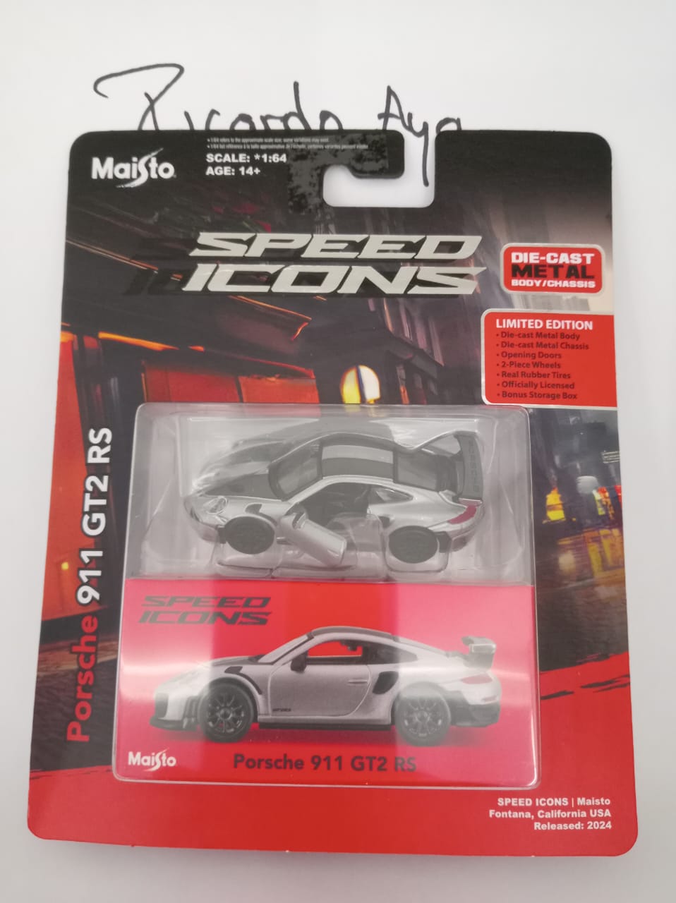 Front of satchel with blue canvas body, black straps and handle, drawstring top, and front zipper pouch.