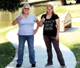 Patricia Keyes and a younger woman smile and give a thumbs up