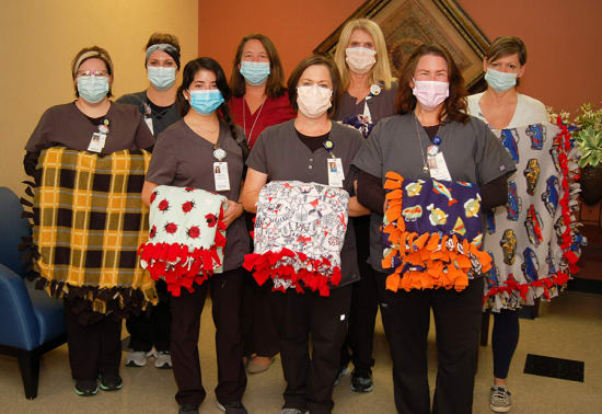 Lake Regional Health System Diagnostic Imaging staff pose with handmade blankets for Lake Regional Cancer Center patients. Pictured left to right in front row are Samantha Klopping, Ronda Kempf and Kristy Wood. In the back row are Jetty Meyer, Jessica Butler, Kim Gericke, Karen Bischof and Ashley Schmidt.