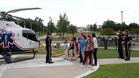 Phil Wilkenson, an Air Methods paramedic, shows the Career Camp students the Staff for Life helicopter based at Lake Regional Health System. Also pictured are Air Methods pilots Daniel Doornink and Caleb Barnes.