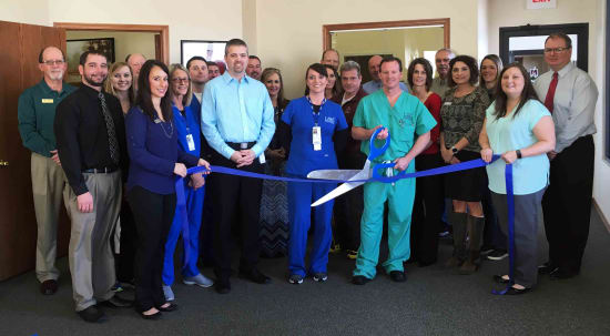 Brian Swanson, P.A. (front row, third from left), and Orthopedic Surgeon Jeff Jones, D.O. (front row with scissors), celebrate the opening of Lake Regional Orthopedics - Camdenton with members of the Camdenton Area Chamber of Commerce and representatives of Lake Regional Health System.