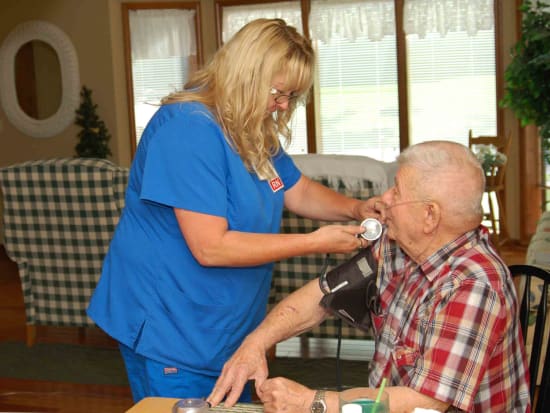 Lake Regional Nurse Toshia Melton checks hospice patient Donald Simpson's vitals during a home visit.
