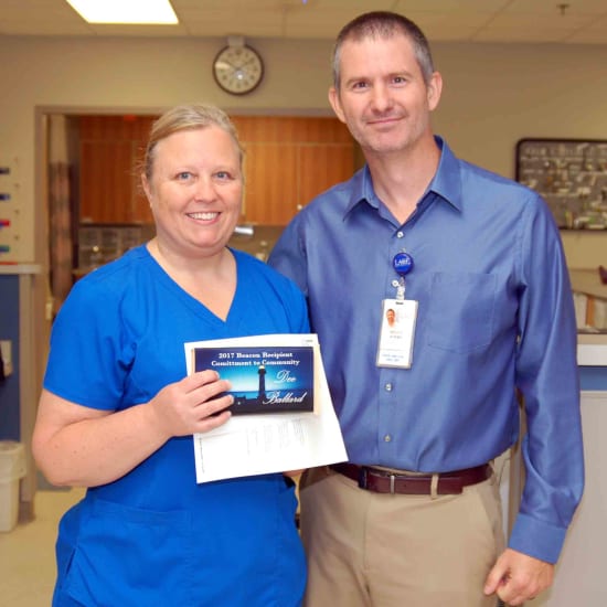 Dee Ballard, R.N., winner of the Beacon of Commitment to Community, and Bruce Adams, HR assistant director