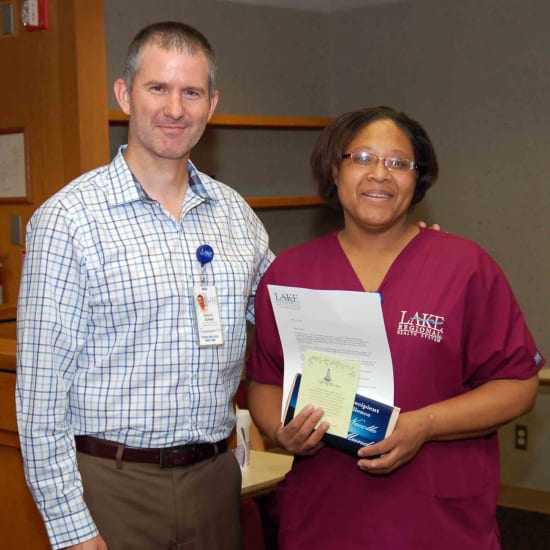Bruce Adams, HR assistant director, and Necolle Mundy, winner of the Beacon of Service Excellence