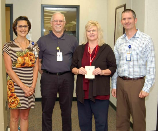 Lorrie Haden, director of Patient Financial Services; Fred Goecker, director of Revenue Cycle; Donna Scott, winner of the Beacon of Integrity; , and Bruce Adams, HR assistant director