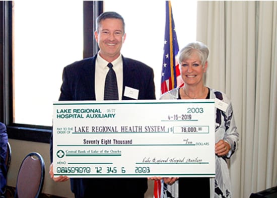 Lake Regional Health System CEO Dane W. Henry, FACHE, accepts a check for $78,000 presented by Jayne Brown, Auxiliary president, on behalf of the Lake Regional Hospital Auxiliary.