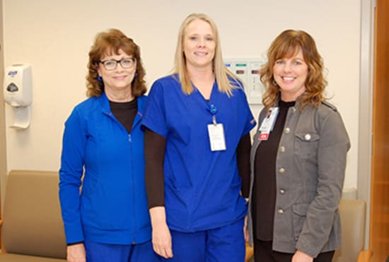 Jeri Swanson, R.N., center, receives the Spirit of Nursing award from Kelly Phillips, Outpatient Services/Surgical Center unit lead, and Hunter.
