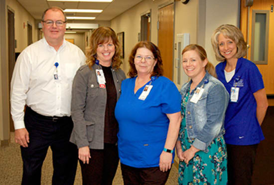 Judy Mahoney, LPN, center, receives the Licensed Practical Nurse of the Year award, from Kevin McRoberts, FACHE, senior vice president of Operations; Hunter; Brandi Kincaid, NP-C, AOCNP; and Marcy Maxwell, Cancer Services director.