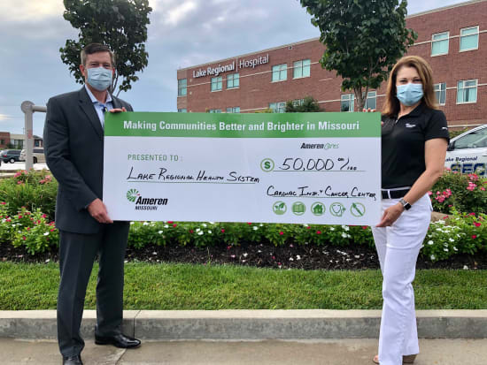 Lake Regional Health System CEO Dane W. Henry, FACHE, accepts a check for $50,000 presented by Lori Hoelscher, regional account executive, on behalf of Ameren Missouri.